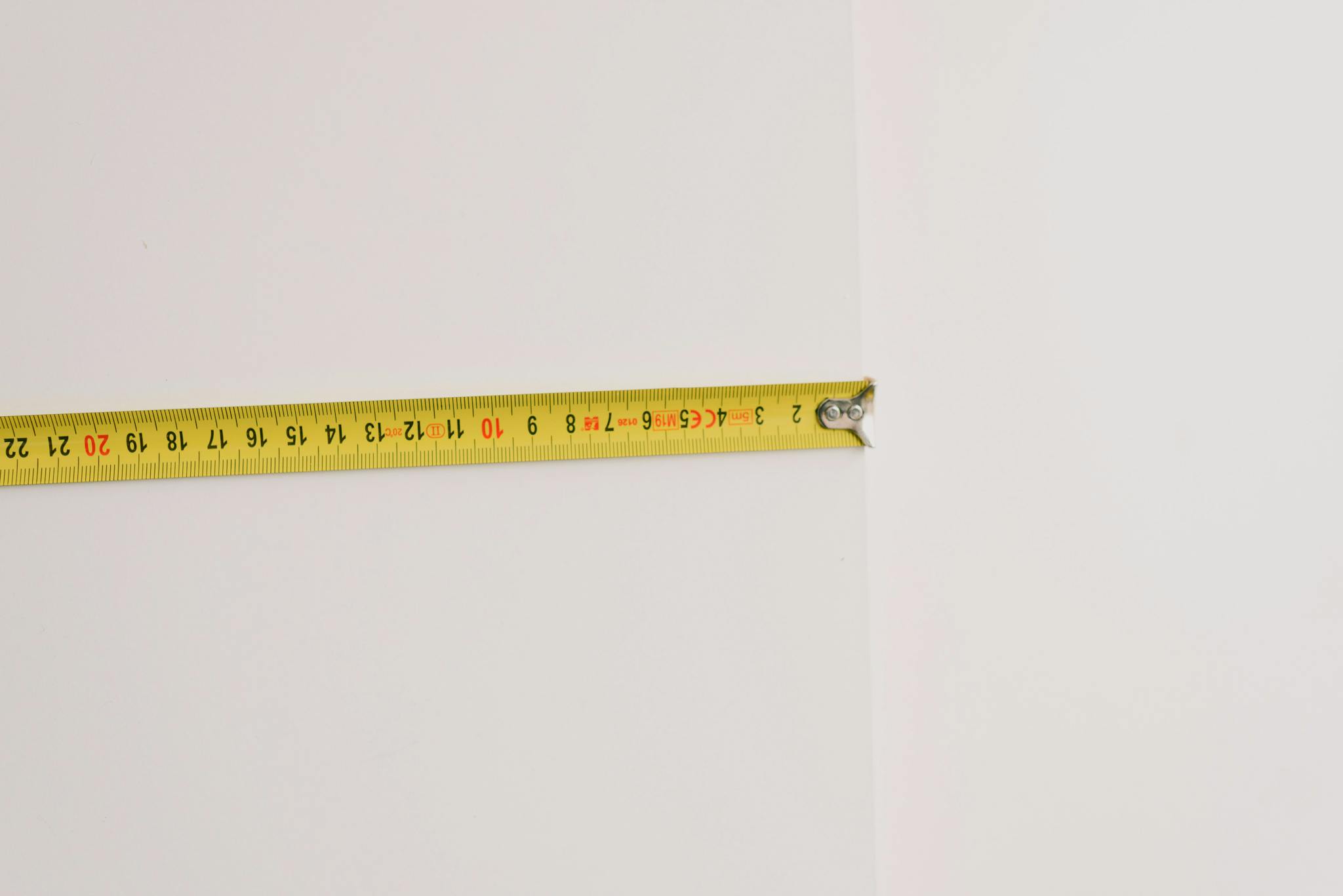 Measuring tape on empty white background